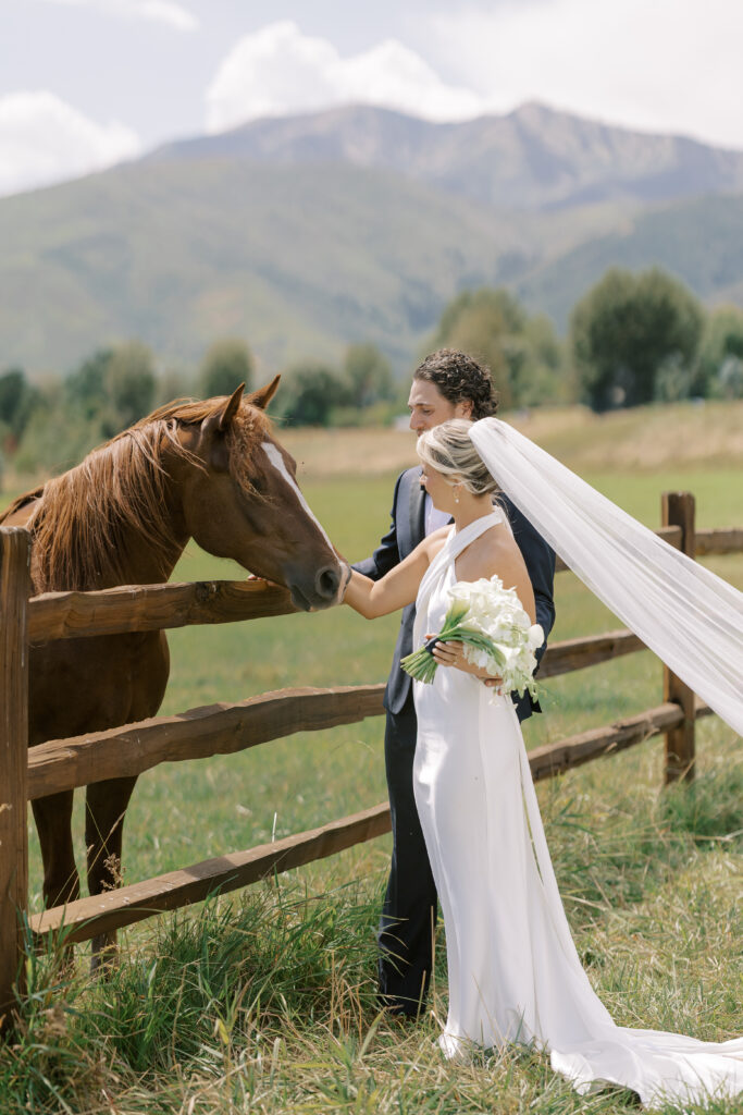 Luxury wedding bouquet with cascading white orchids and calla lilies against mountain wedding backdrop in Utah
