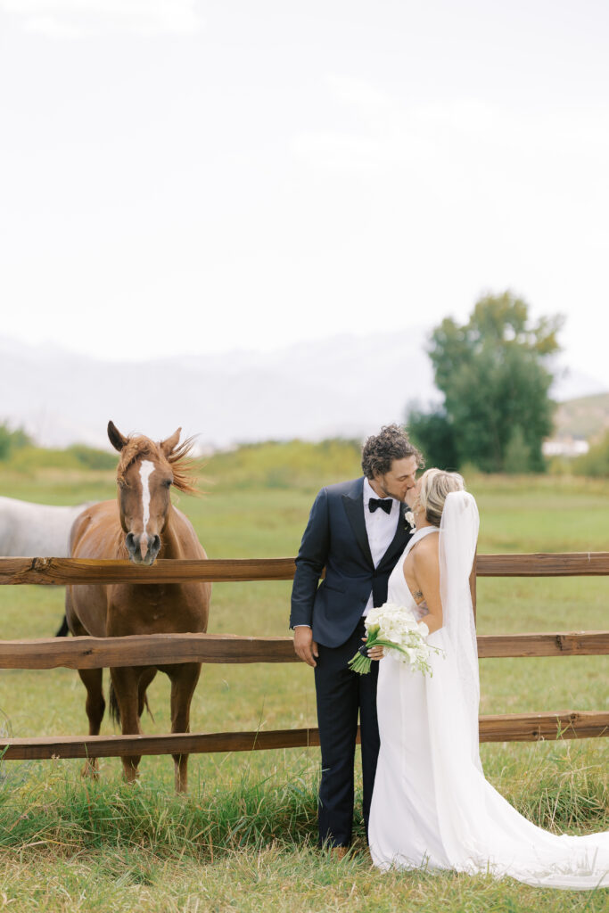 Luxury wedding bouquet with cascading white orchids and calla lilies against mountain wedding backdrop in Utah