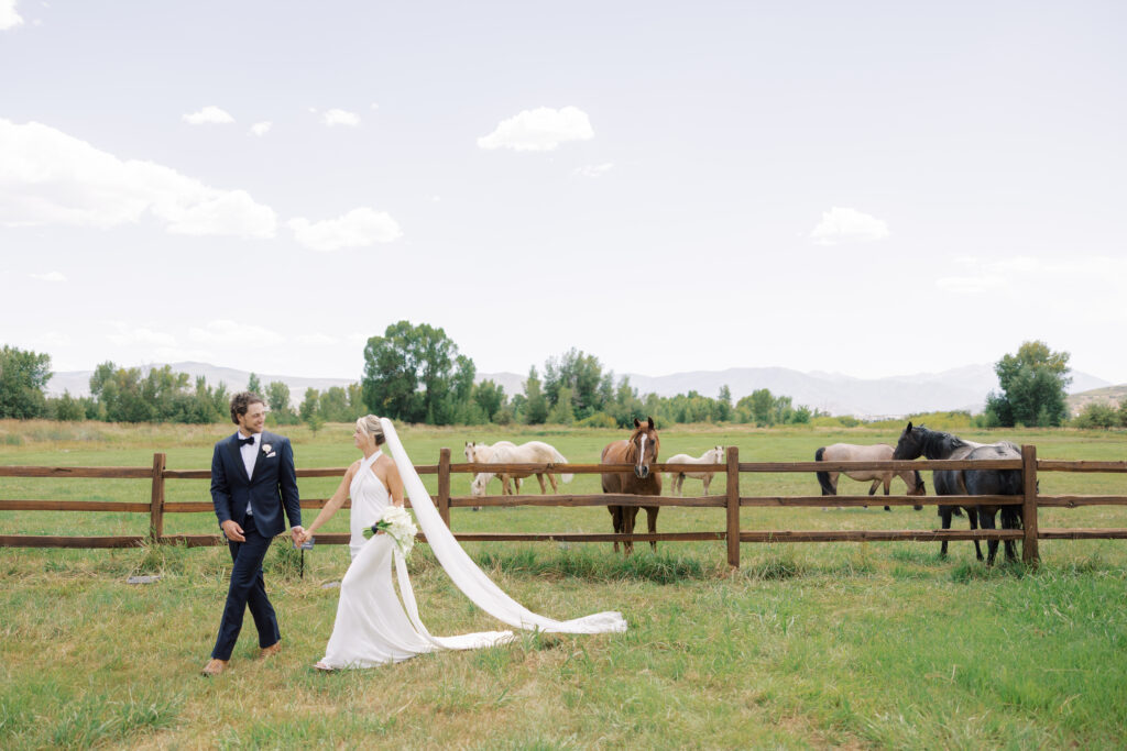 Luxury wedding bouquet with cascading white orchids and calla lilies against mountain wedding backdrop in Utah